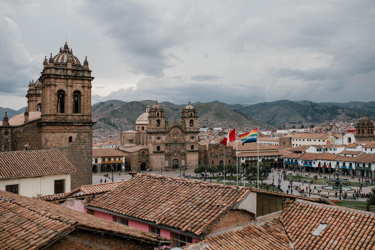 Cityscape of medieval church and houses with old tile roof in Cusco Peru