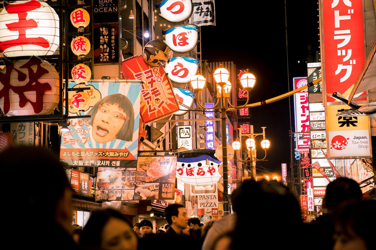 Crowd Surrounded by Buildings during Night Time - Japan