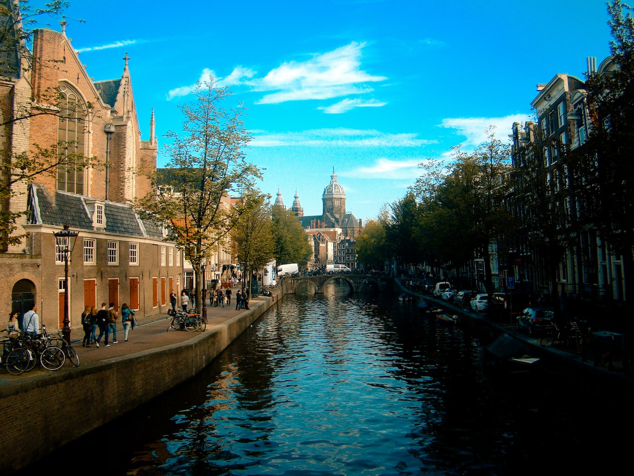 People Walking Beside River Under White Cloudy Sky - Amsterdam