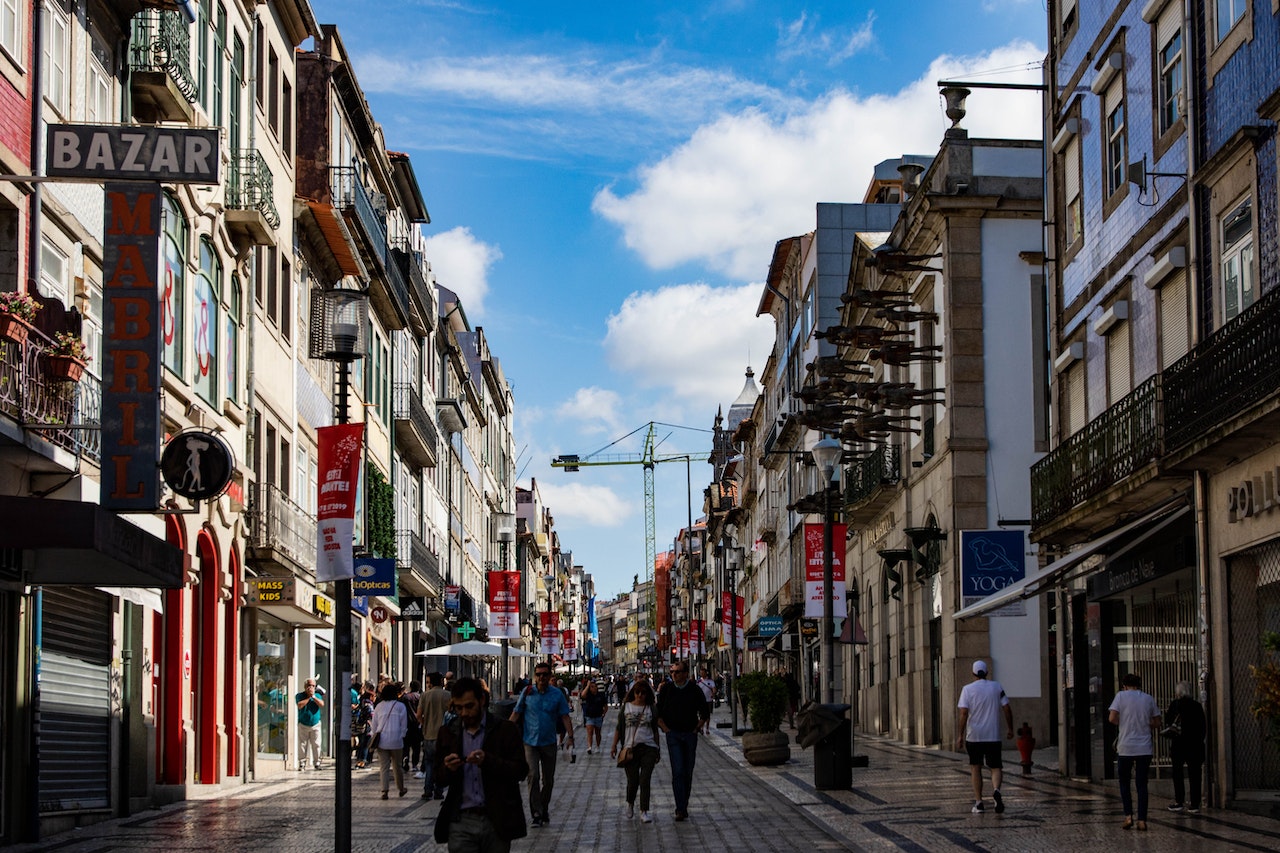 Photo of People Walking on Street Near Buildings