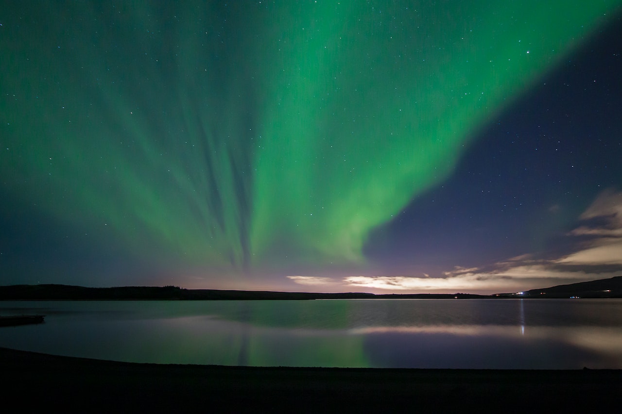 The View of the Northern Lights in Hafravatn Lake in Iceland