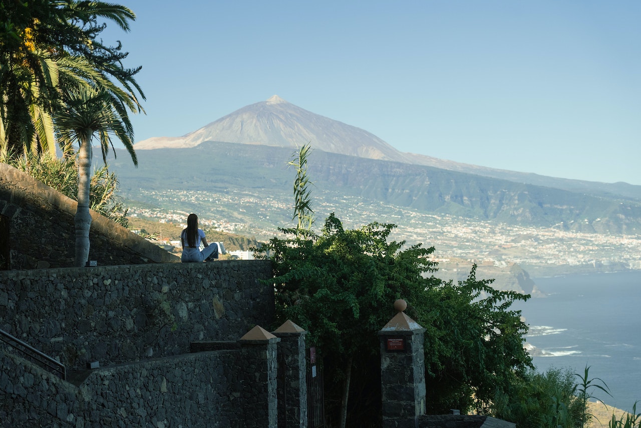 Woman Sitting on a Wall and Looking at the Teide Volcano in Tenerife, Canary Islands